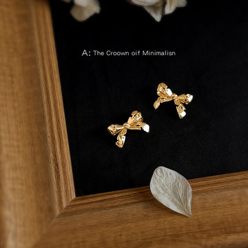 Gold Tone Sculpted Bow Stud Earrings With Stitched Ribbon Detail