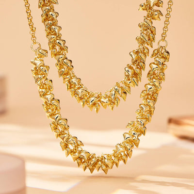 Neckline view of hollow heart charm chain necklaces in main image 1.
