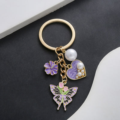 Front product photo of purple pink and blue heart pearl flower butterfly keychain showing the pictured design arrangemen