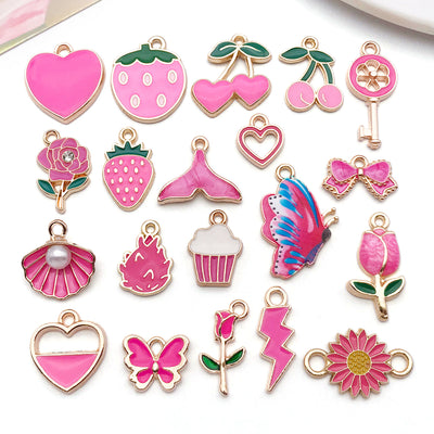 Colorful strawberry and bow charms arranged on a light background