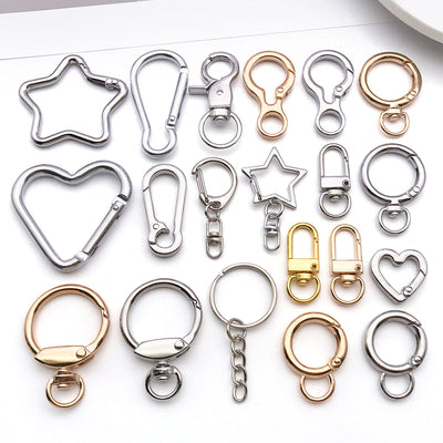 Metallic swivel clasp jewelry findings arranged on a light background