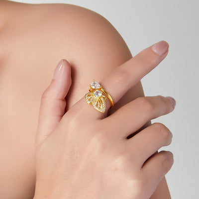 Gold zircon butterfly open ring worn on finger against shoulder
