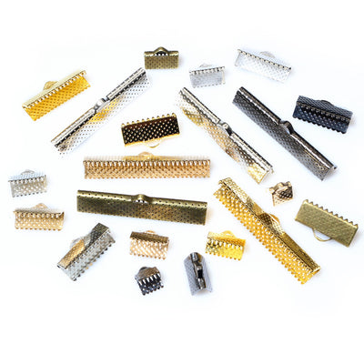 Front overview of serrated ribbon end clamps in mixed sizes and finishes arranged on a light background