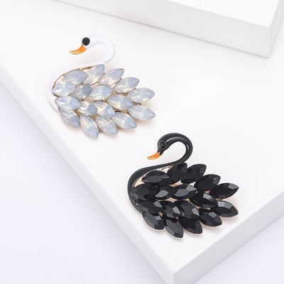 Layered Marquise Crystal Swan Brooch in Black or White shown from the front on a white background