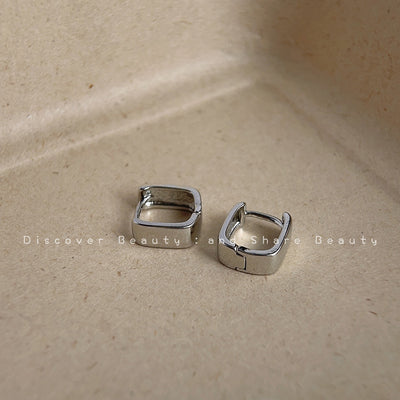 Silver-tone mirror-polished rectangular huggie hoops in the first product display.