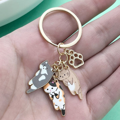 Image 1 showing a person holding a keychain with two dogs.