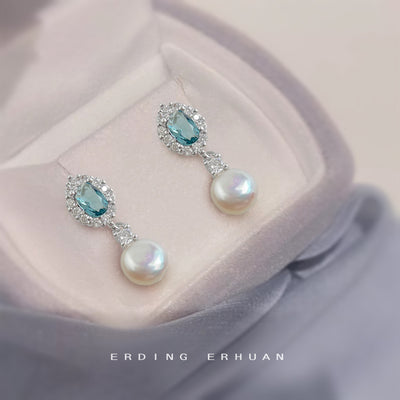 Silver aqua crystal halo pearl drop studs on pink gray fabric