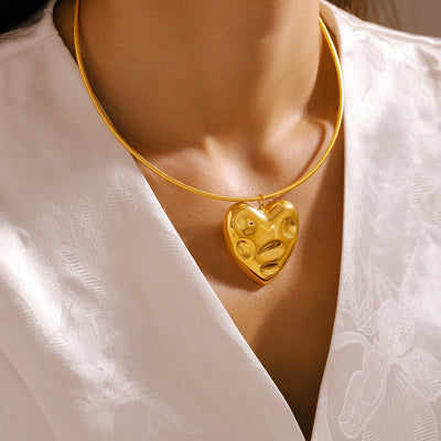 Gold molten heart snake chain necklace worn on white blouse