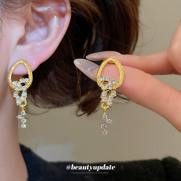 Gold Tone Crystal Oval Tassel Drop Earrings With Star Accents
