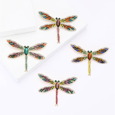 A slender dragonfly with multicolor crystal wings shown on a white background