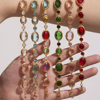 Hand holding six multicolor gold oval bezel Czech glass station bracelets