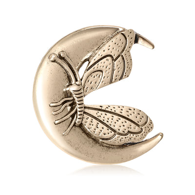 Front view of embossed butterfly resting inside a textured crescent moon