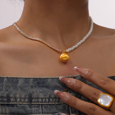 Model wearing gold zircon and pearl split necklace with matte ball pendant