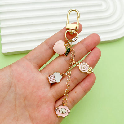 Image 1 showing a hand holding two different shaped charms.