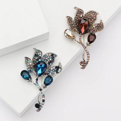 Blue and purple crystal calla leaf brooches on white blocks