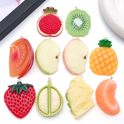 Multicolor pineapple charms arranged on a light background