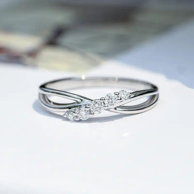 Product view showing silver-tone open leaf infinity clear-stone ring