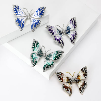 Front view of the layered metal enamel butterfly brooch in four colorways brooch and its color options