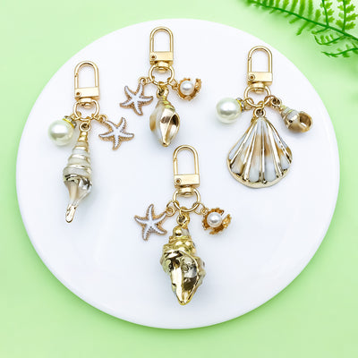 Image 1 showing a white plate topped with gold and silver charms.