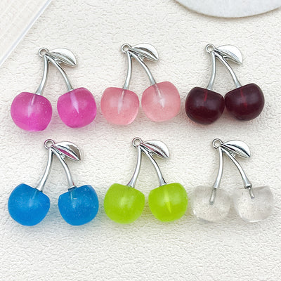 Multicolor cherry charms arranged on a light background