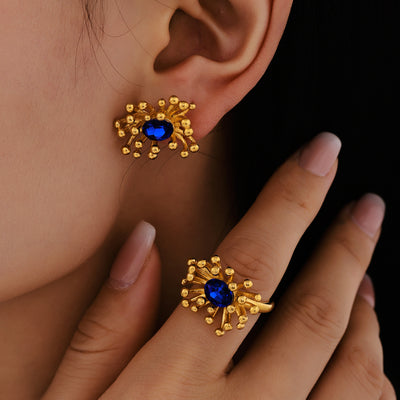 Gold blue zircon starburst flower earring and matching ring worn