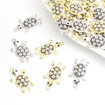 Assorted turtle charms arranged on a white surface
