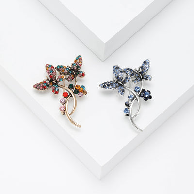 butterfly and crystal flower stem brooch group view
