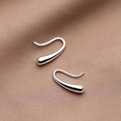 silver tone earrings showing minimal elongated teardrop hooks with polished rounded ends