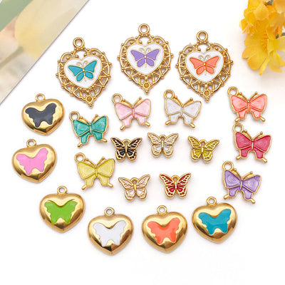 Colorful heart and butterfly charms arranged on a light background