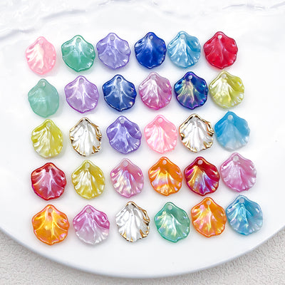 Iridescent assorted shape charms arranged on a light background