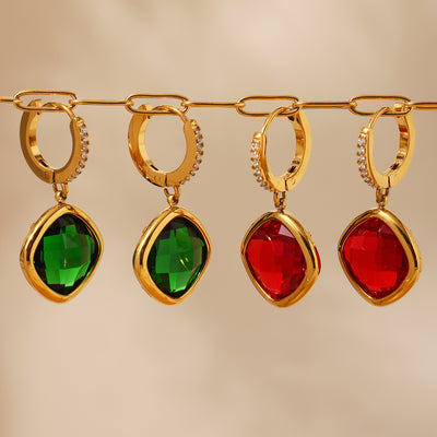 Green and red gold cushion glass drop earrings hanging on gold chain rack