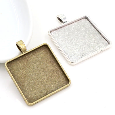square cabochon pendant trays arranged together on a white background