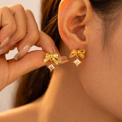 Gold textured bow square zircon drop studs worn on model ears