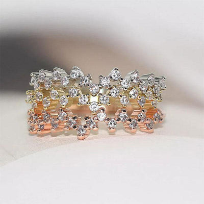 Three stacked gold rose white scattered CZ mini star rings