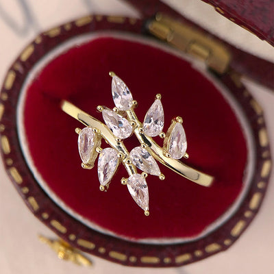 Gold leaf marquise spray ring on red velvet box top view