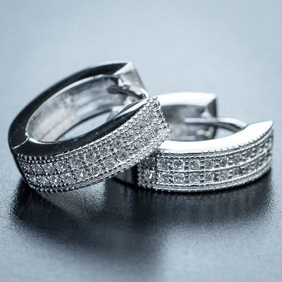 White metal triple row pave huggie hoops pair on gray