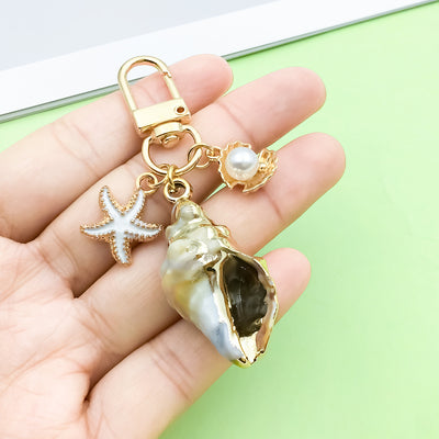 Image 1 showing starfish, conch and shell keychains shown in the product image.