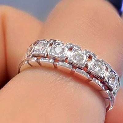 Front view of square crystal eternity style band ring in silver tone