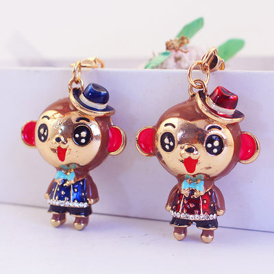 Blue and red monkey keychain charms displayed side by side.