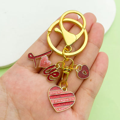 Image 1 showing a person holding two different shaped key chains.