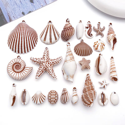 Multicolor seashell and starfish charms arranged on a light background