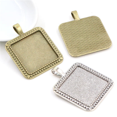Overview of square pendant bezel trays with beaded borders and textured backs on a light background