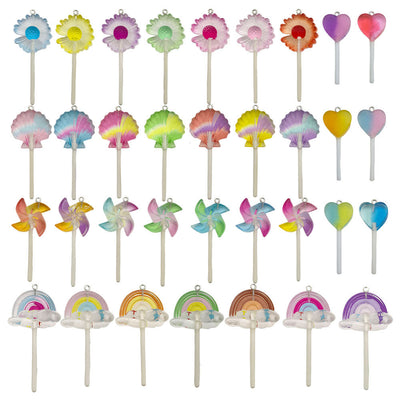 Multicolor lollipop and daisy charms arranged on a light background