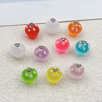 Colorful mushroom charms arranged on a light background