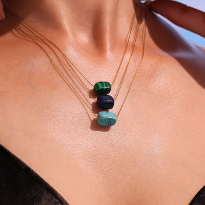 Layered lapis malachite and turquoise bead pendant necklaces on model