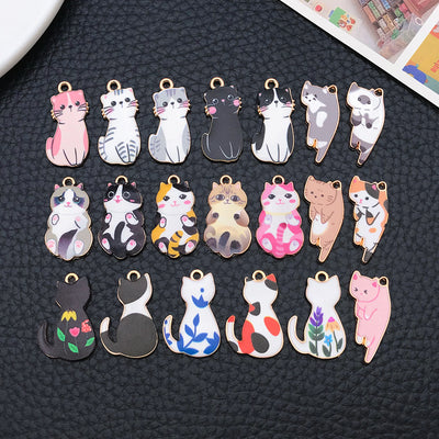 Colorful cat charms arranged on a light background
