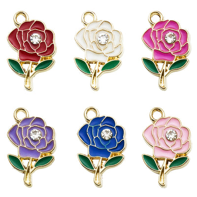 Gold-tone flower charms arranged on a light background