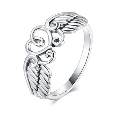 Silver angel wings open heart band ring angled white background