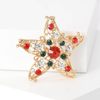 Gold filigree starfish brooch front on white blocks