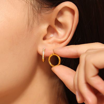 Gold zircon-paved mini hoop worn with matching hoop held nearby